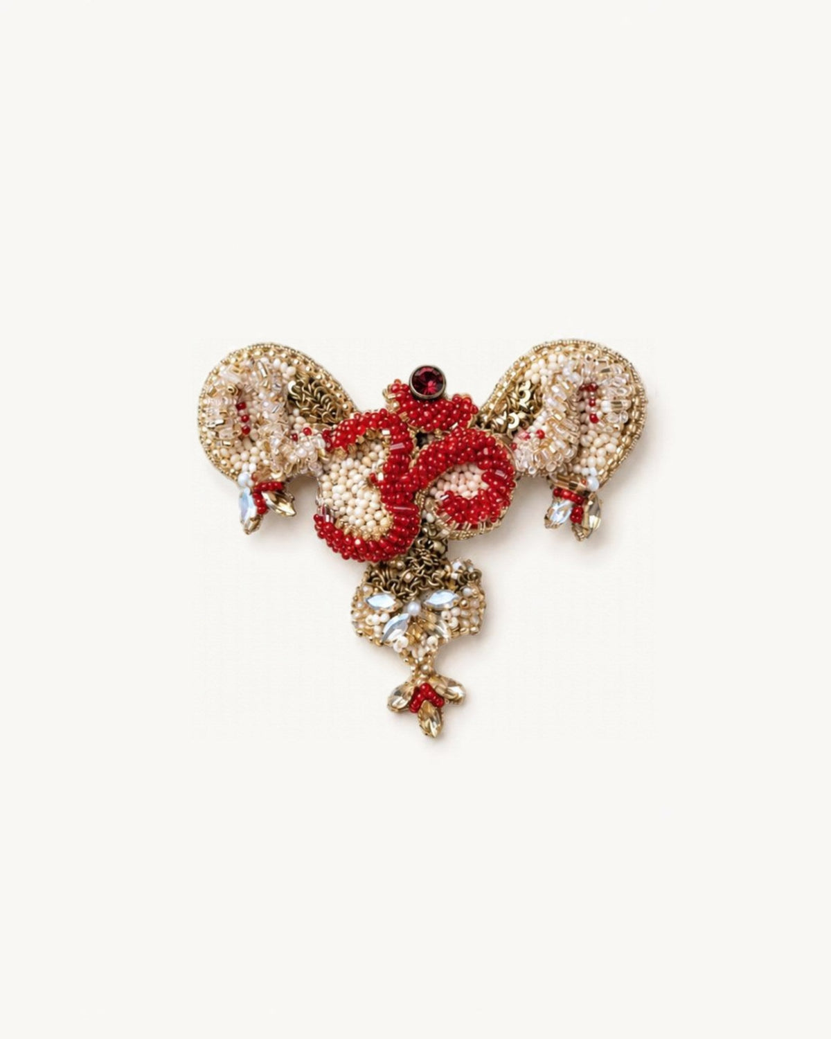 The Gladys uterus anatomy dress pin with an Om at its center by House of Rednam