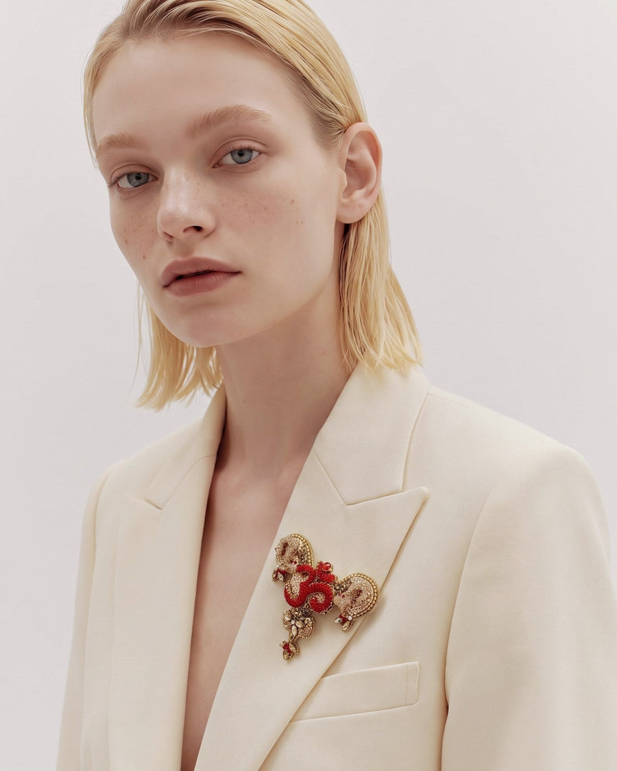 The Gladys uterus anatomy dress pin with an Om at its center by House of Rednam