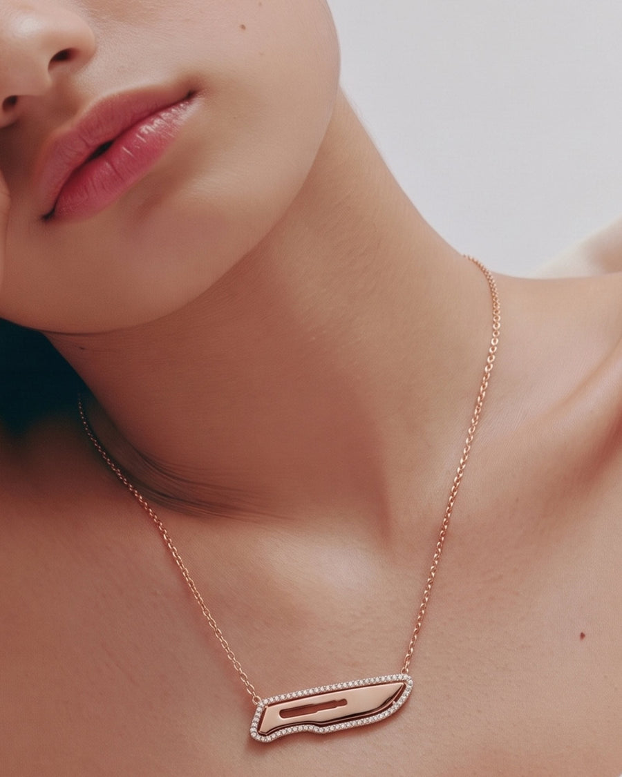 The Kiran 18K gold scalpel necklace with diamond halo by House of Rednam