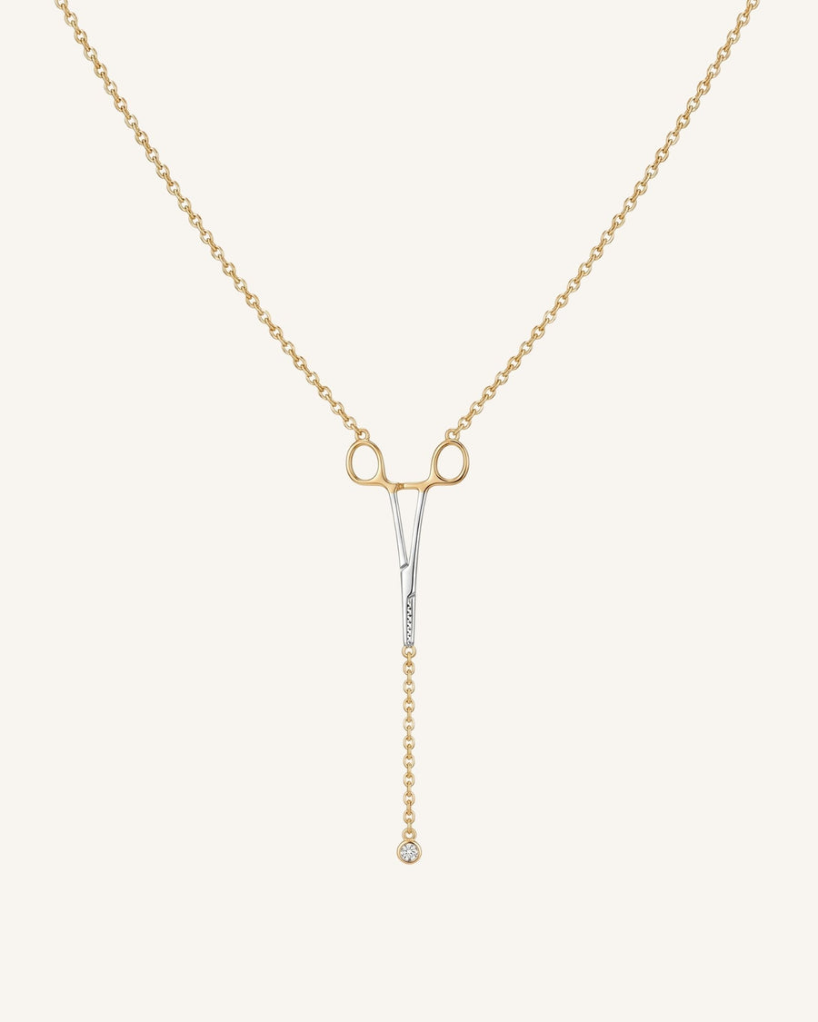 The Erin two-tone hemostat necklace in 18K yellow and white gold with a natural diamond at the hinge by House of Rednam