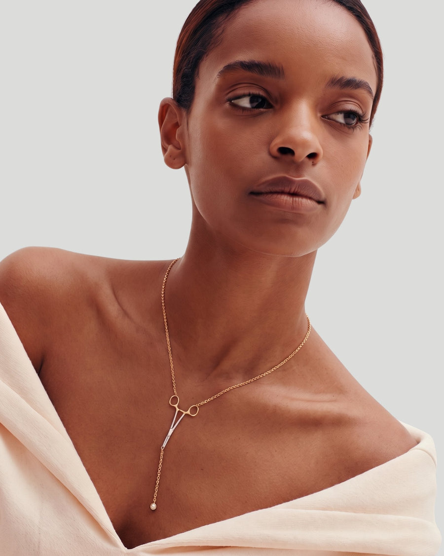 The Erin two-tone hemostat necklace in 18K yellow and white gold with a natural diamond at the hinge by House of Rednam