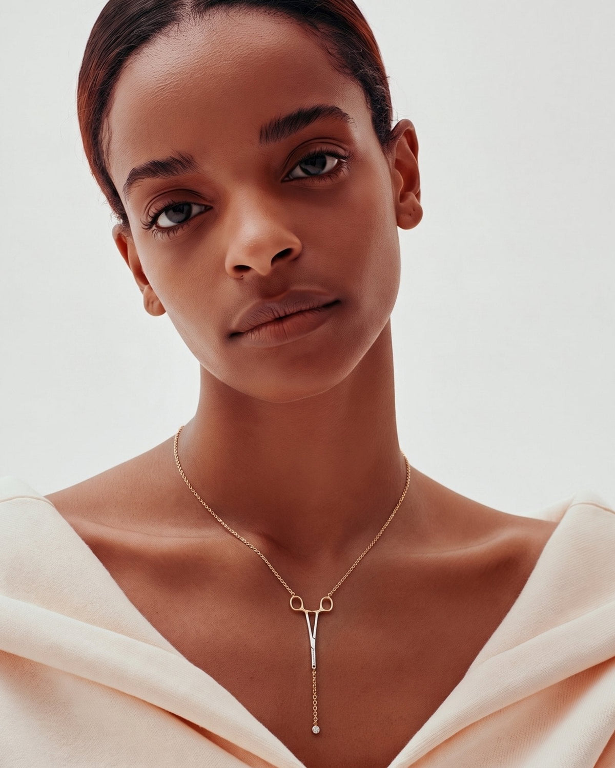 The Erin two-tone hemostat necklace in 18K yellow and white gold with a natural diamond at the hinge by House of Rednam