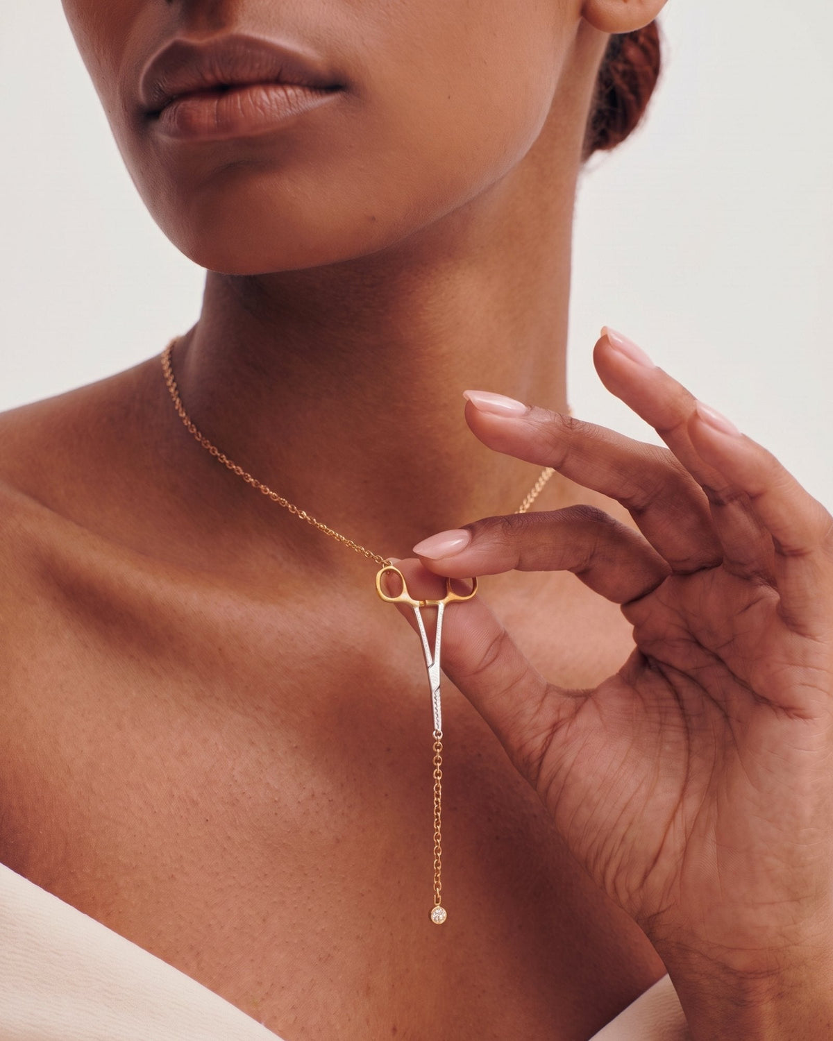 The Erin two-tone hemostat necklace in 18K yellow and white gold with a natural diamond at the hinge by House of Rednam