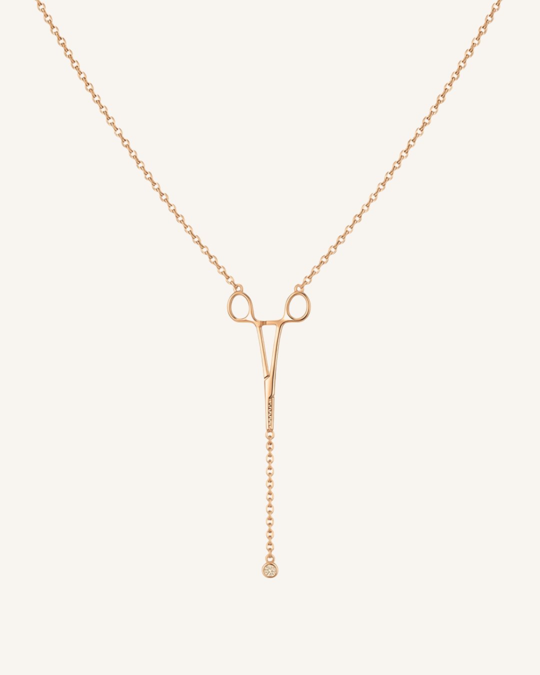 The Erin 18K rose gold hemostat necklace with a diamond at the hinge by House of Rednam