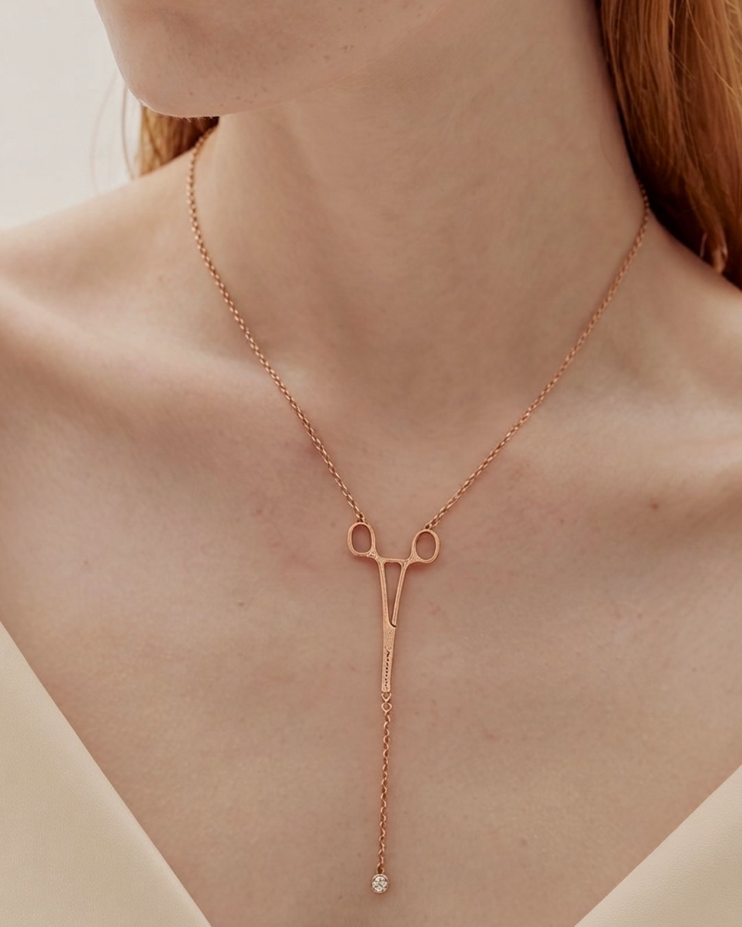 The Erin 18K rose gold hemostat necklace with a diamond at the hinge by House of Rednam
