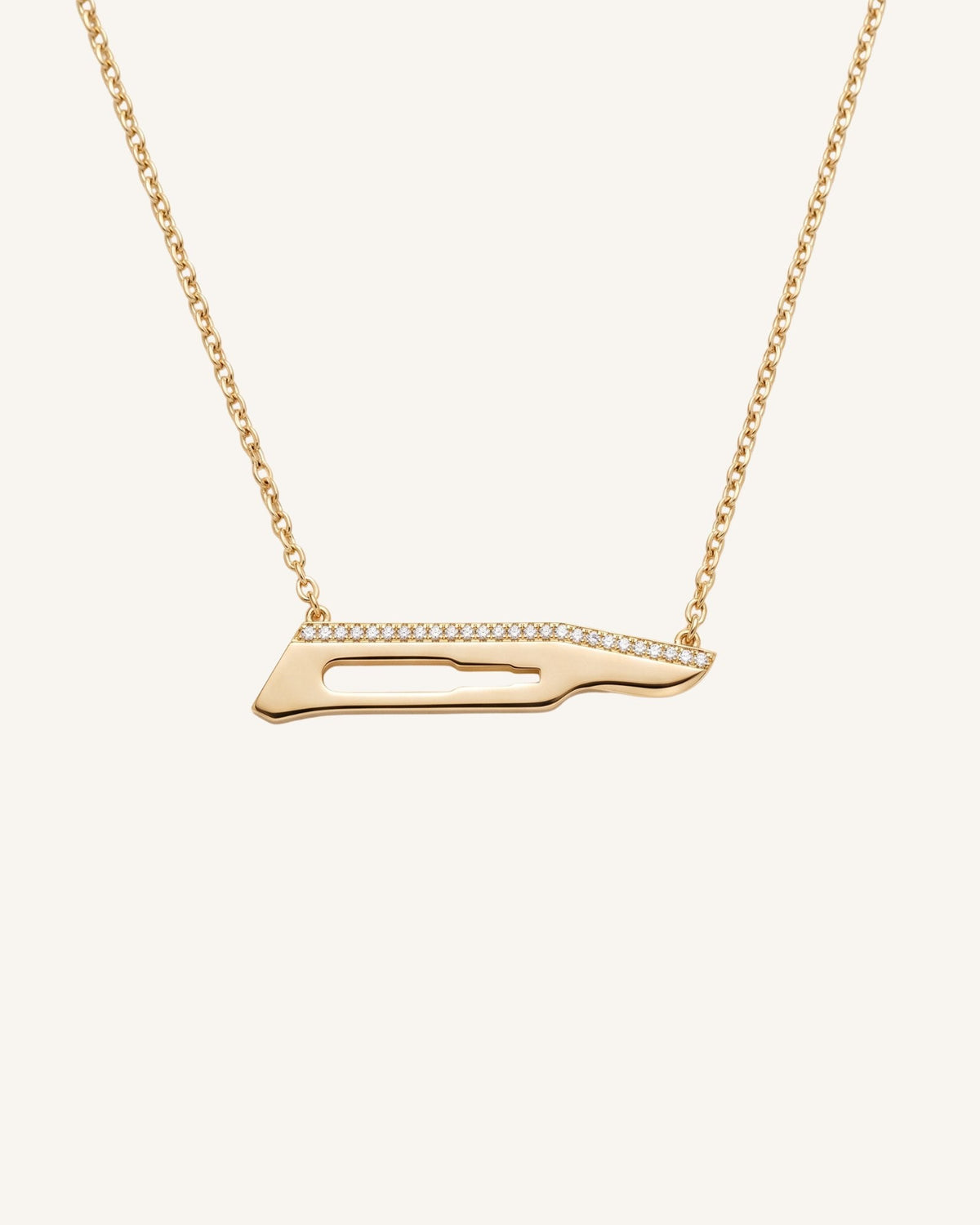 The Kiran No15C scalpel necklace with diamonds on one side in 18K yellow gold by House of Rednam