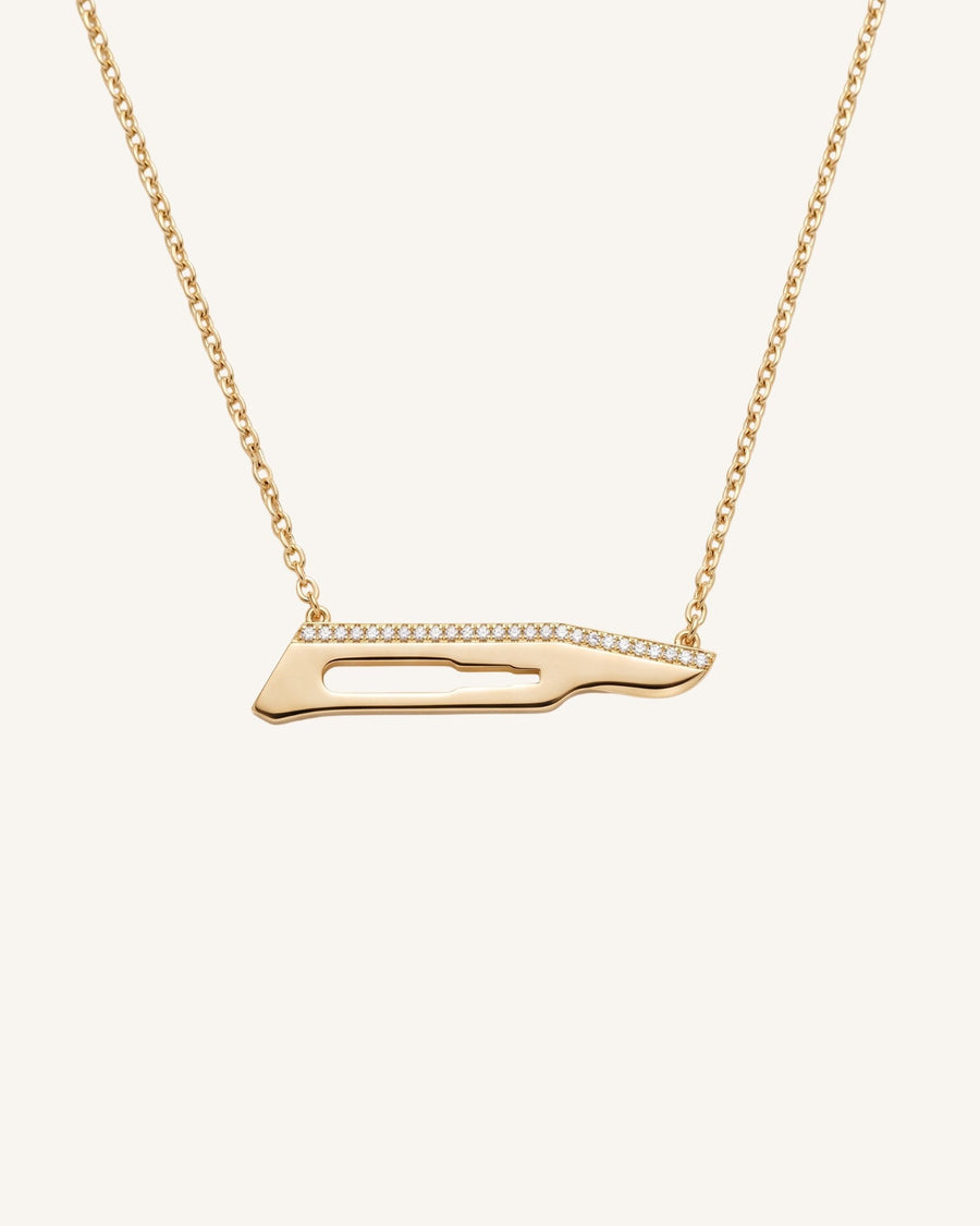 The Kiran No15C scalpel necklace with diamonds on one side in 18K yellow gold by House of Rednam