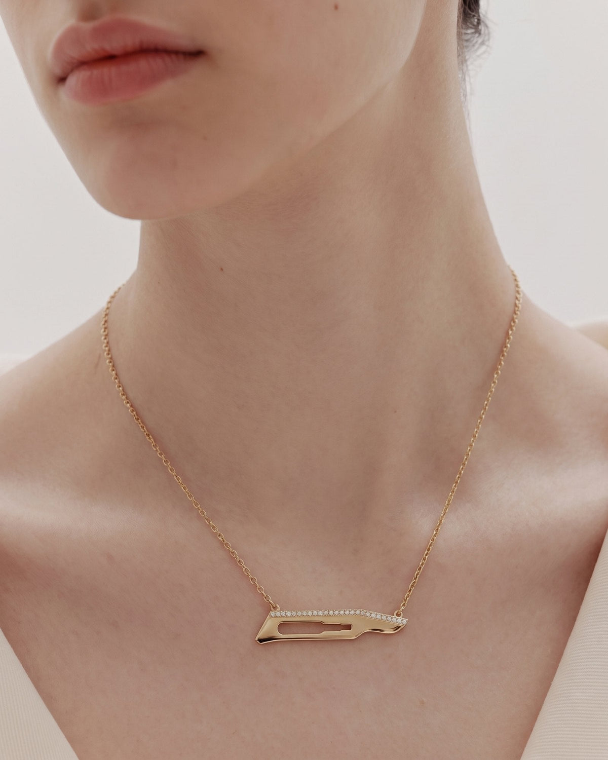 The Kiran No15C scalpel necklace with diamonds on one side in 18K yellow gold by House of Rednam, view 2
