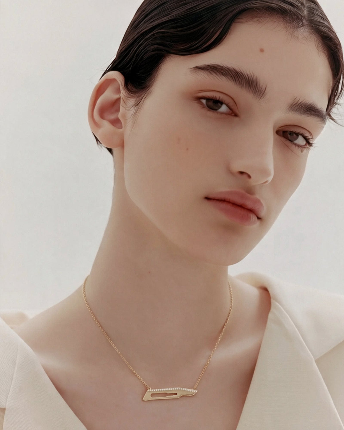 The Kiran No15C scalpel necklace with diamonds on one side in 18K yellow gold by House of Rednam, view 3