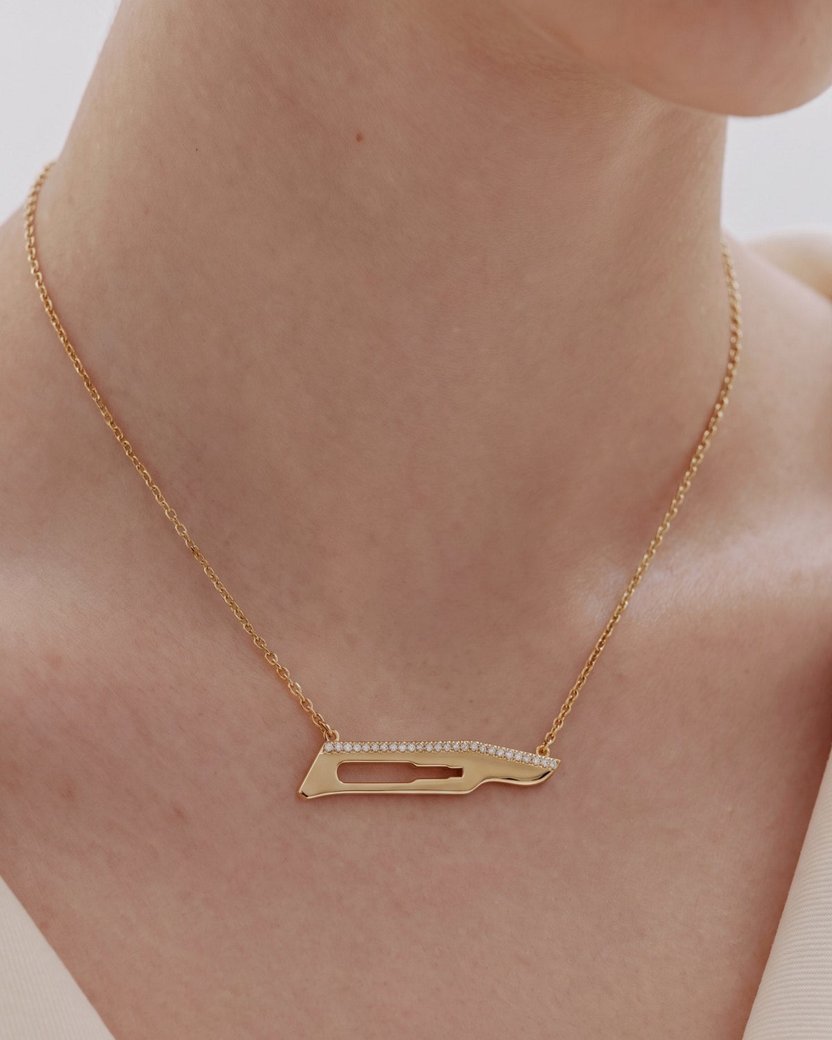The Kiran No15C scalpel necklace with diamonds on one side in 18K yellow gold by House of Rednam, view 4