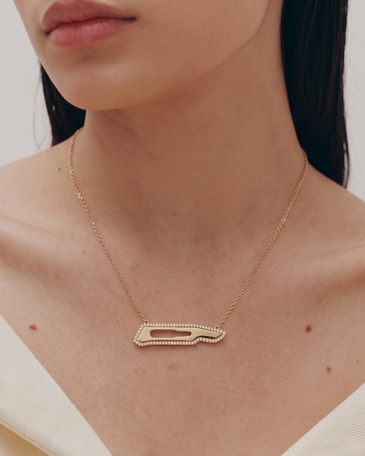The Kiran 18K gold scalpel necklace with diamond halo by House of Rednam