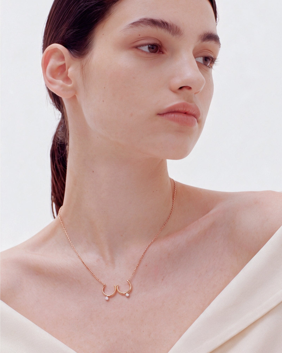 The Priya 18K gold sculpted breast necklace with diamonds by House of Rednam