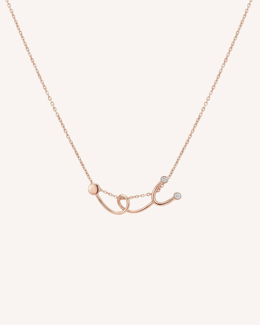 The Surya 18K gold stethoscope necklace with a diamond at each earpiece by House of Rednam