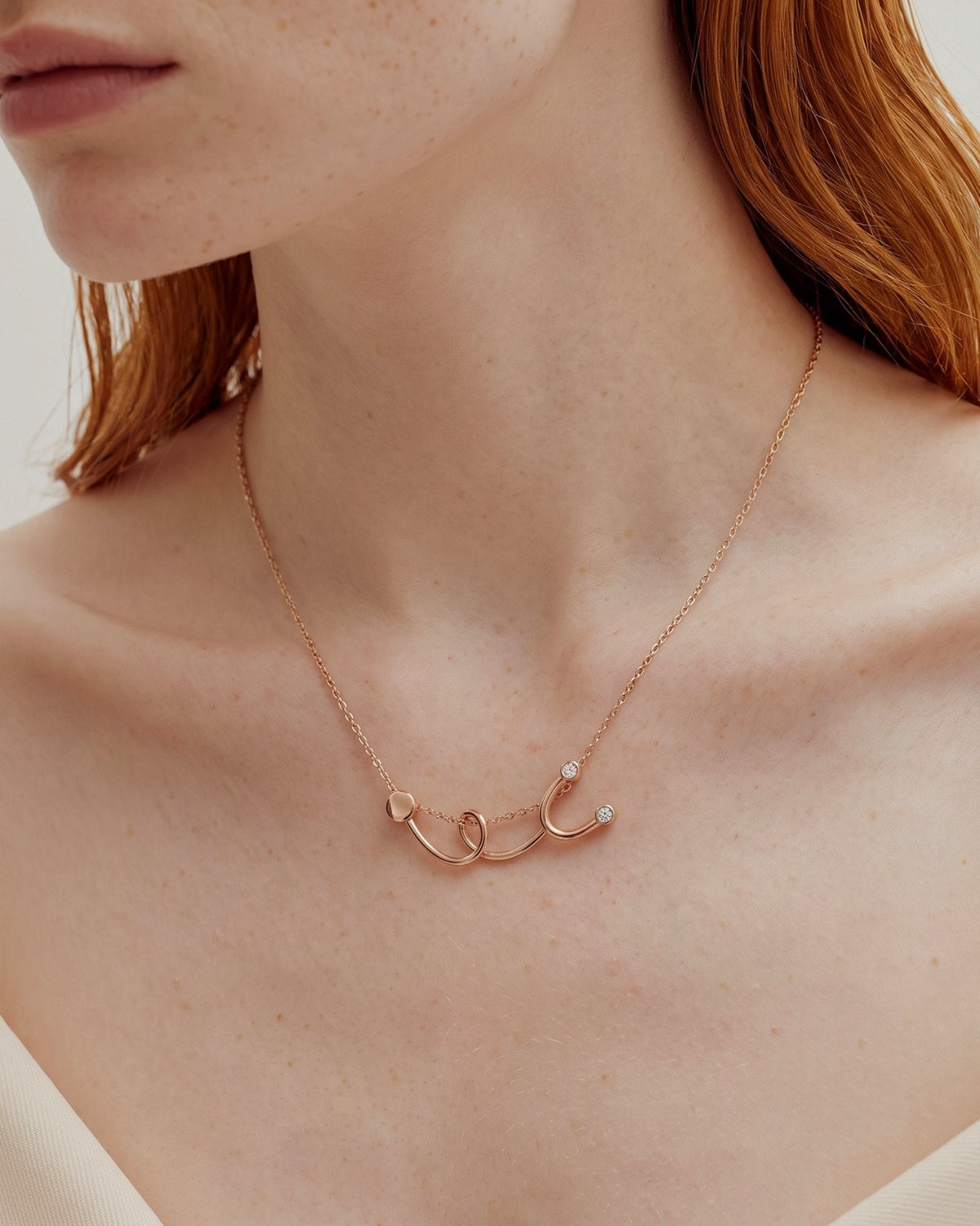 The Surya 18K gold stethoscope necklace with a diamond at each earpiece by House of Rednam