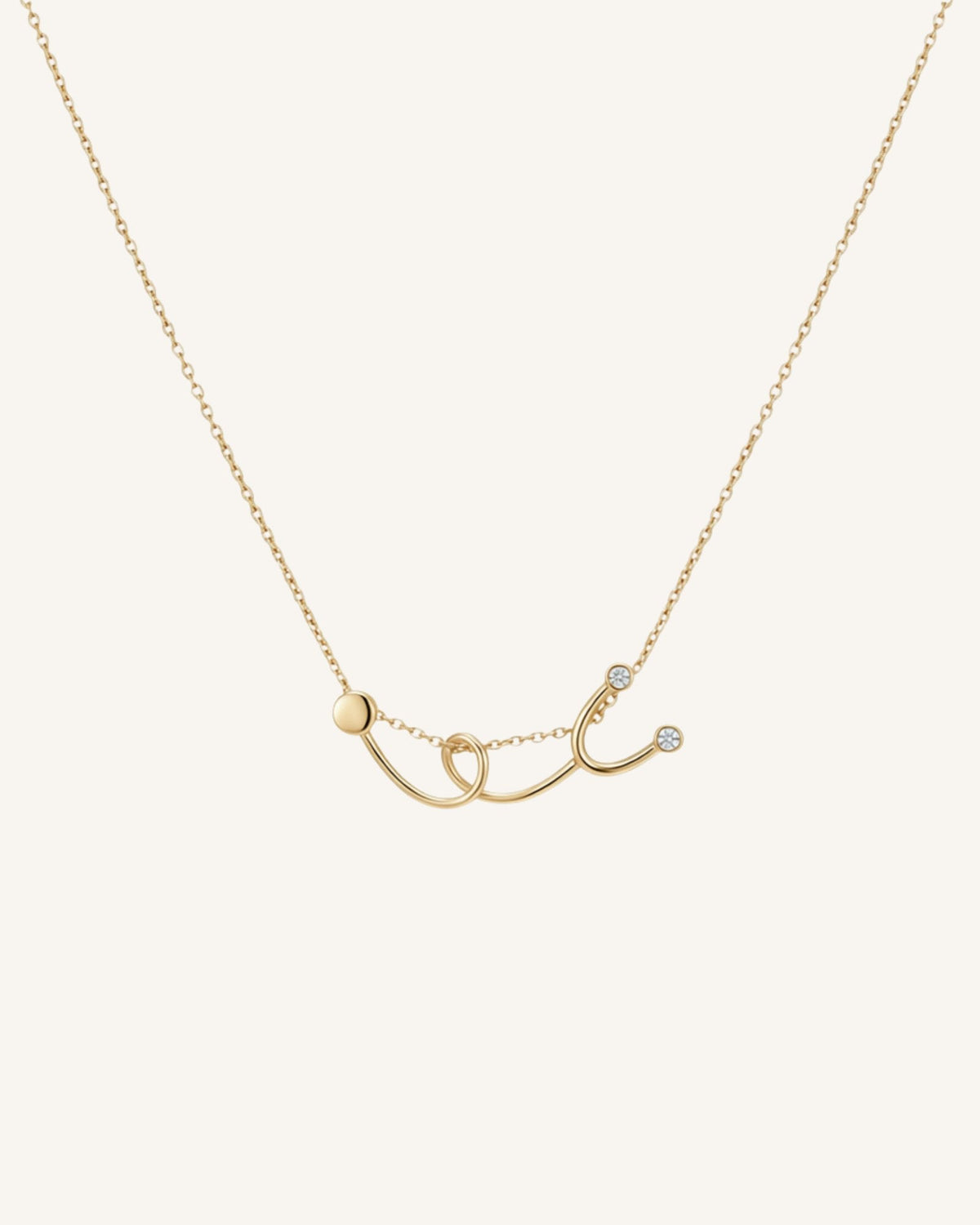 The Surya 18K gold stethoscope necklace with a diamond at each earpiece by House of Rednam