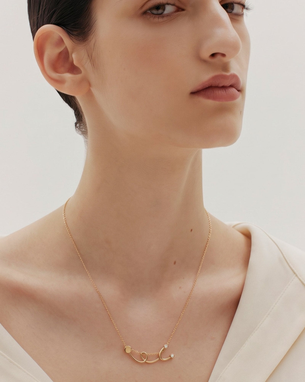 The Surya 18K gold stethoscope necklace with a diamond at each earpiece by House of Rednam