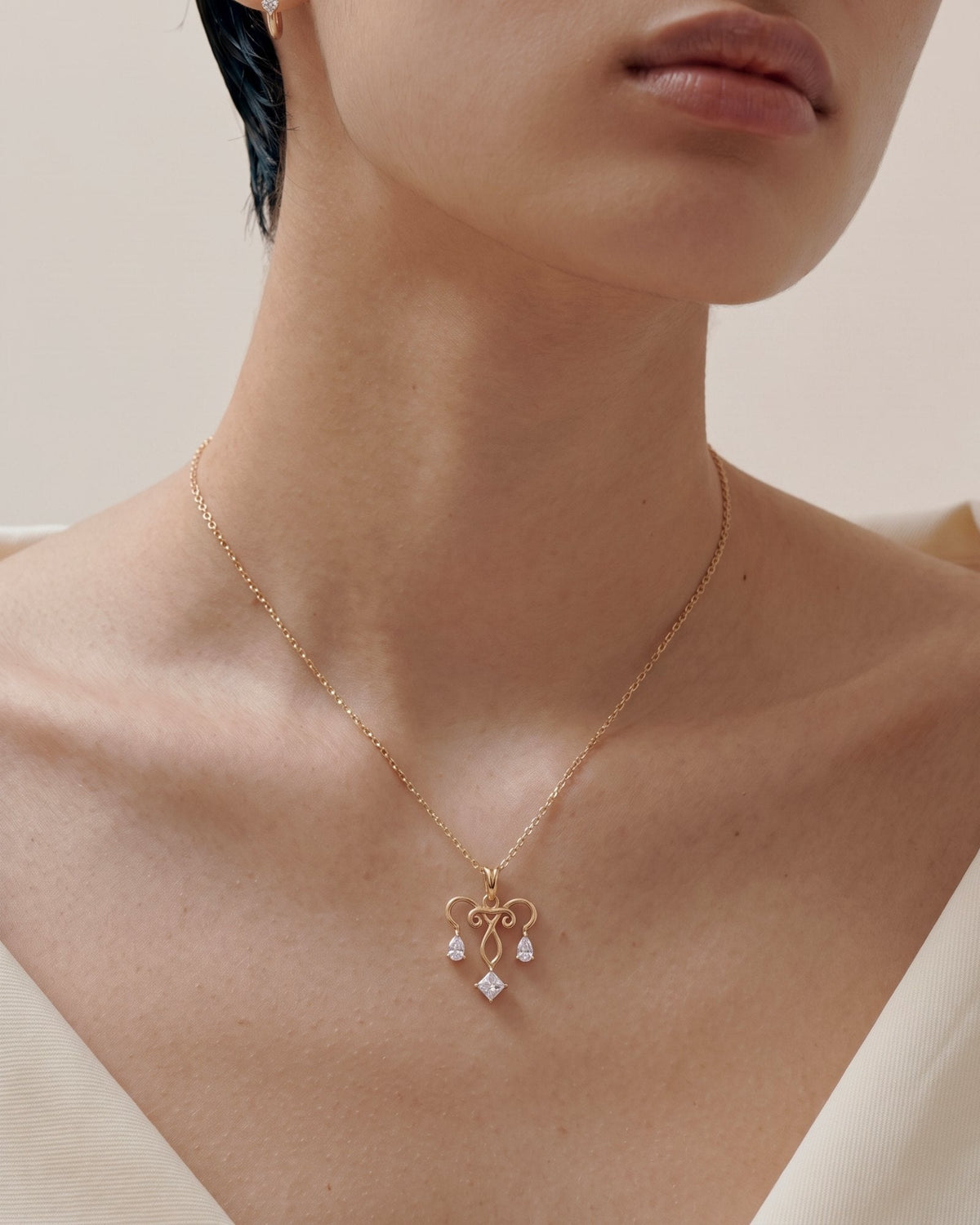 The Chandra 18K gold uterus necklace with diamond ovarian detail by House of Rednam