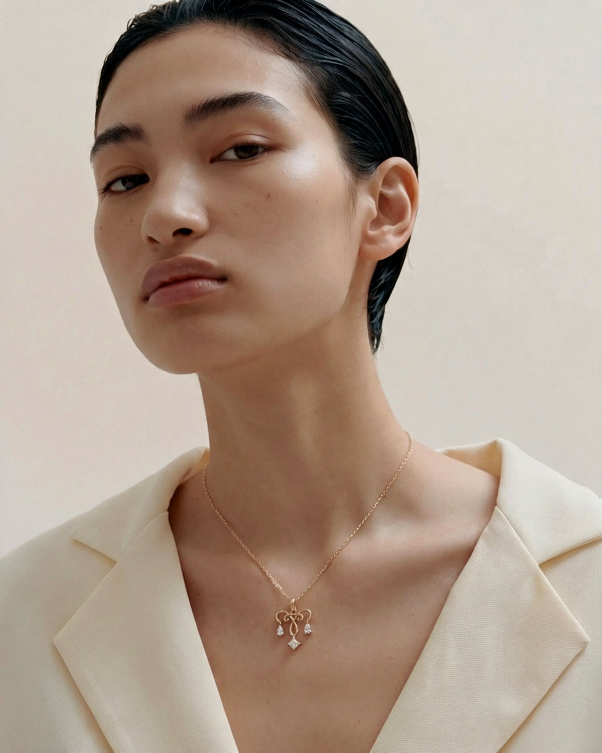 The Chandra 18K gold uterus necklace with diamond ovarian detail by House of Rednam