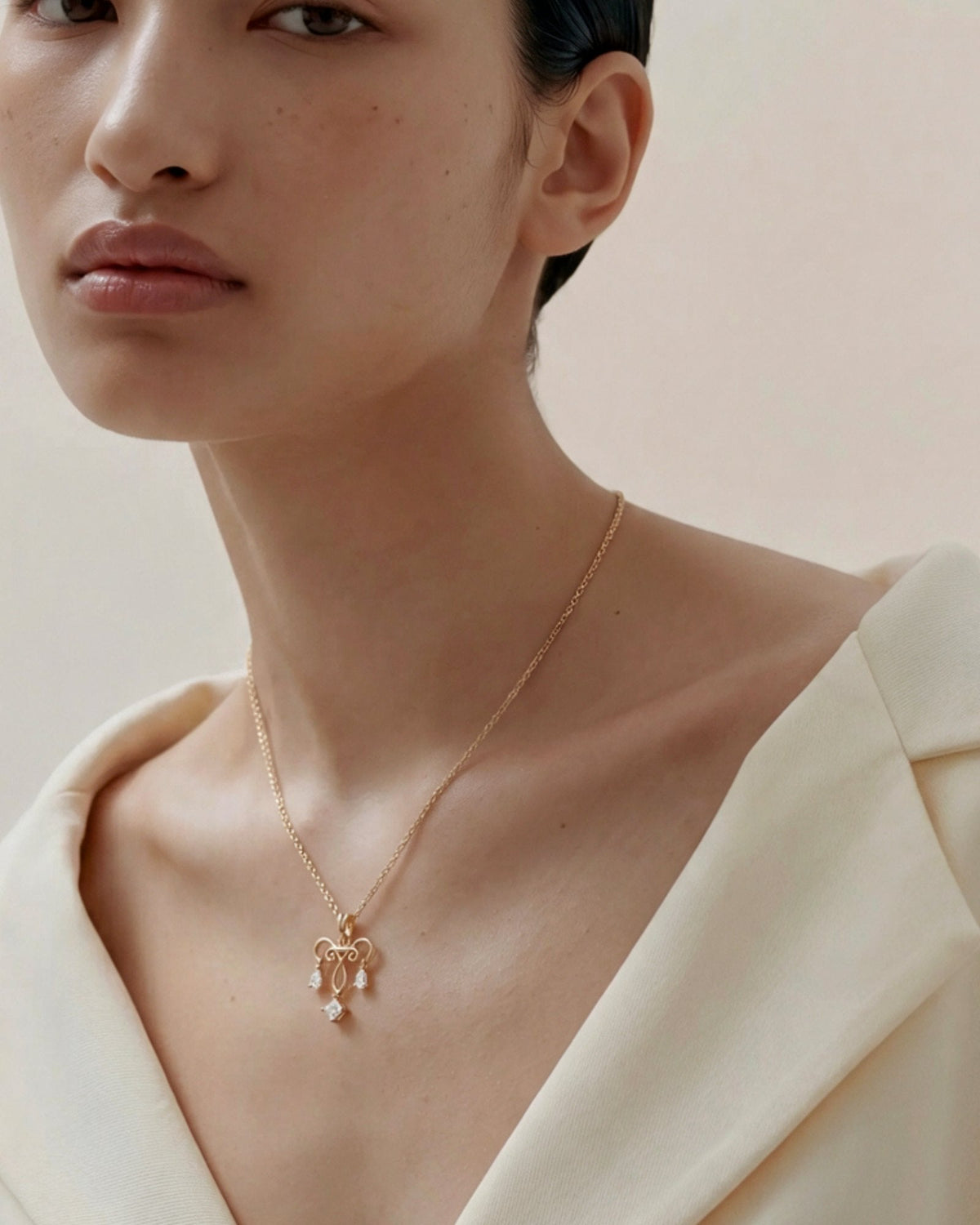 The Chandra 18K gold uterus necklace with diamond ovarian detail by House of Rednam