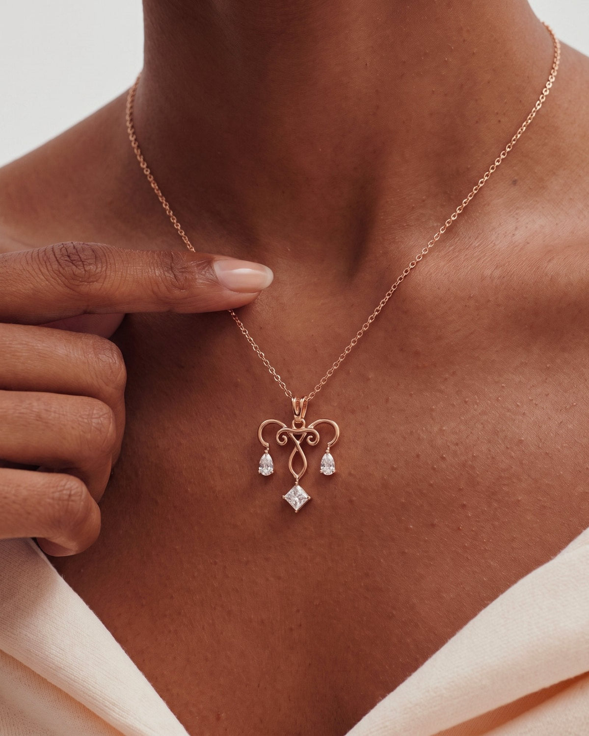 The Chandra 18K gold uterus necklace with diamond ovarian detail by House of Rednam
