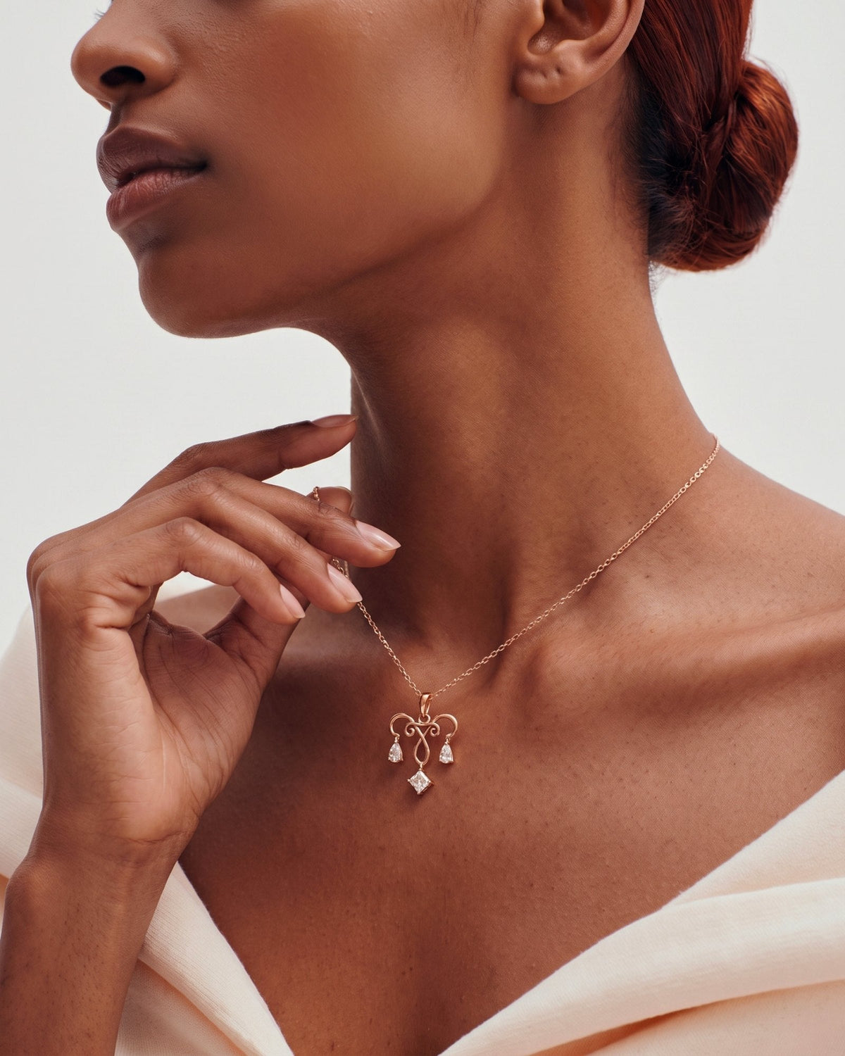 The Chandra 18K gold uterus necklace with diamond ovarian detail by House of Rednam