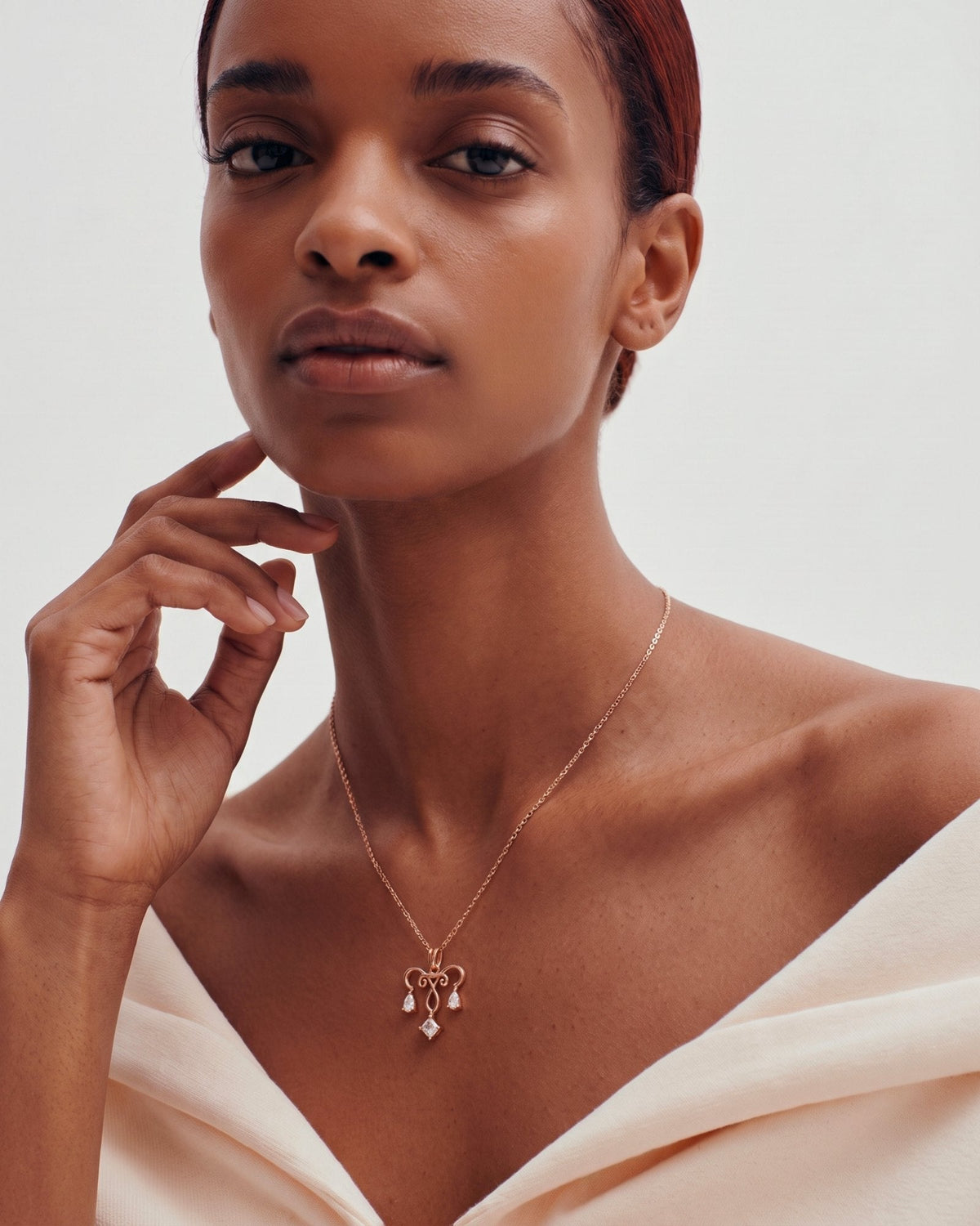 The Chandra 18K gold uterus necklace with diamond ovarian detail by House of Rednam