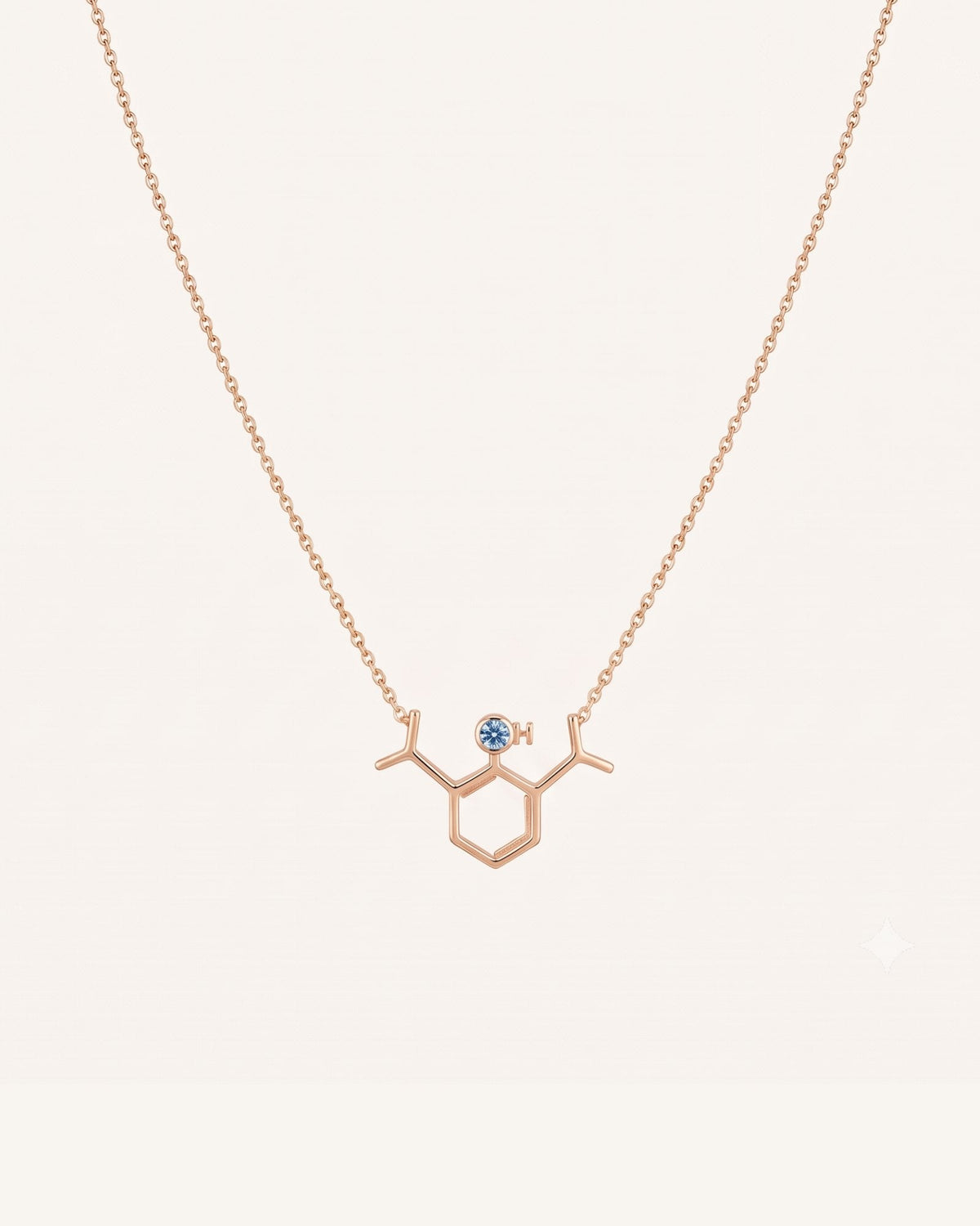 The Johanna 18K gold propofol molecule necklace with blue topaz by House of Rednam