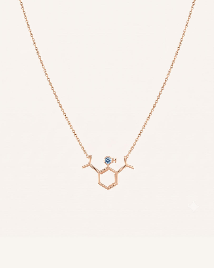 The Johanna 18K gold propofol molecule necklace with blue topaz by House of Rednam