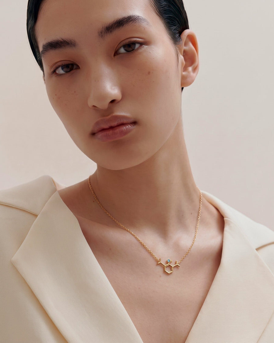 The Johanna 18K gold propofol molecule necklace with blue topaz by House of Rednam