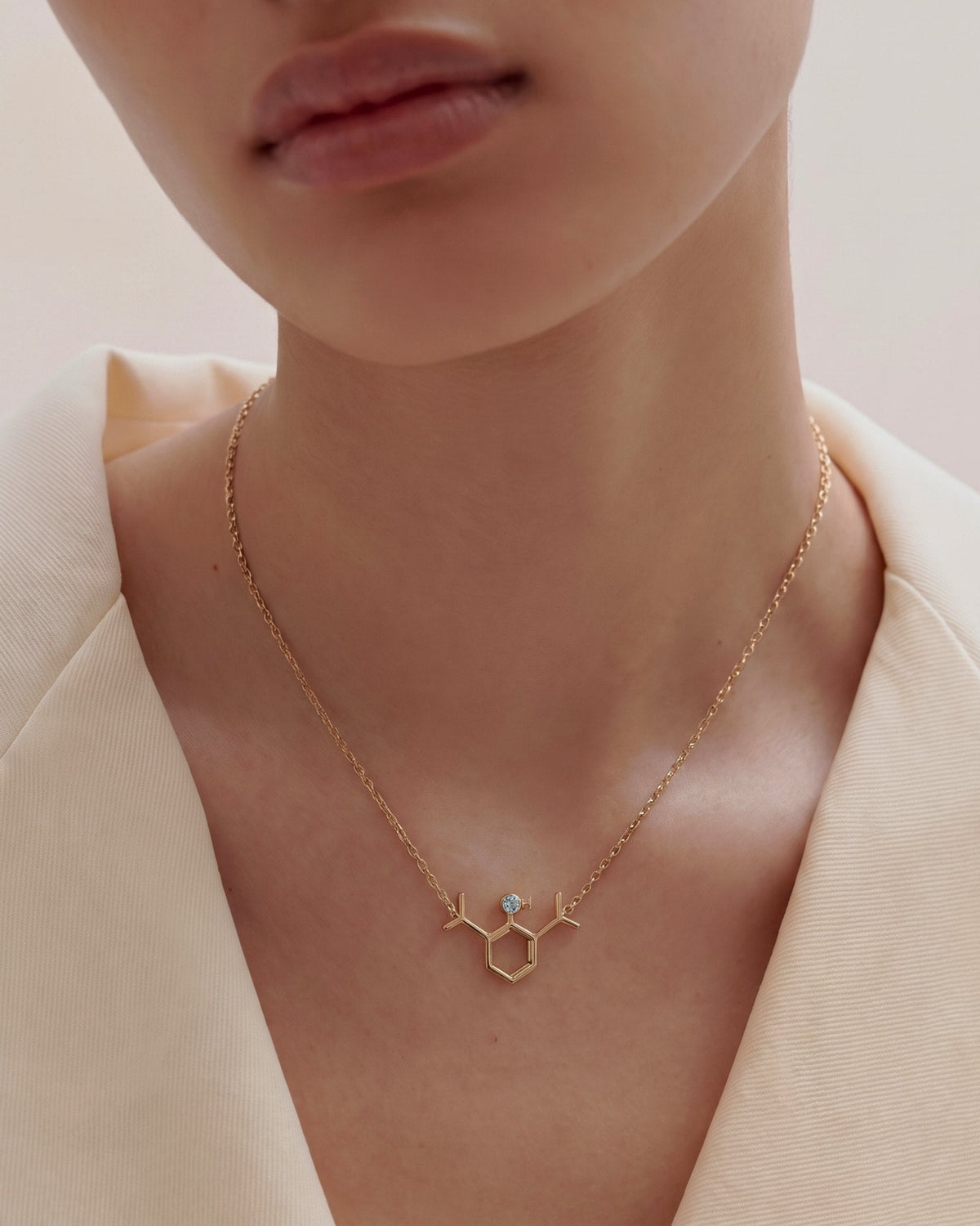 The Johanna 18K gold propofol molecule necklace with blue topaz by House of Rednam