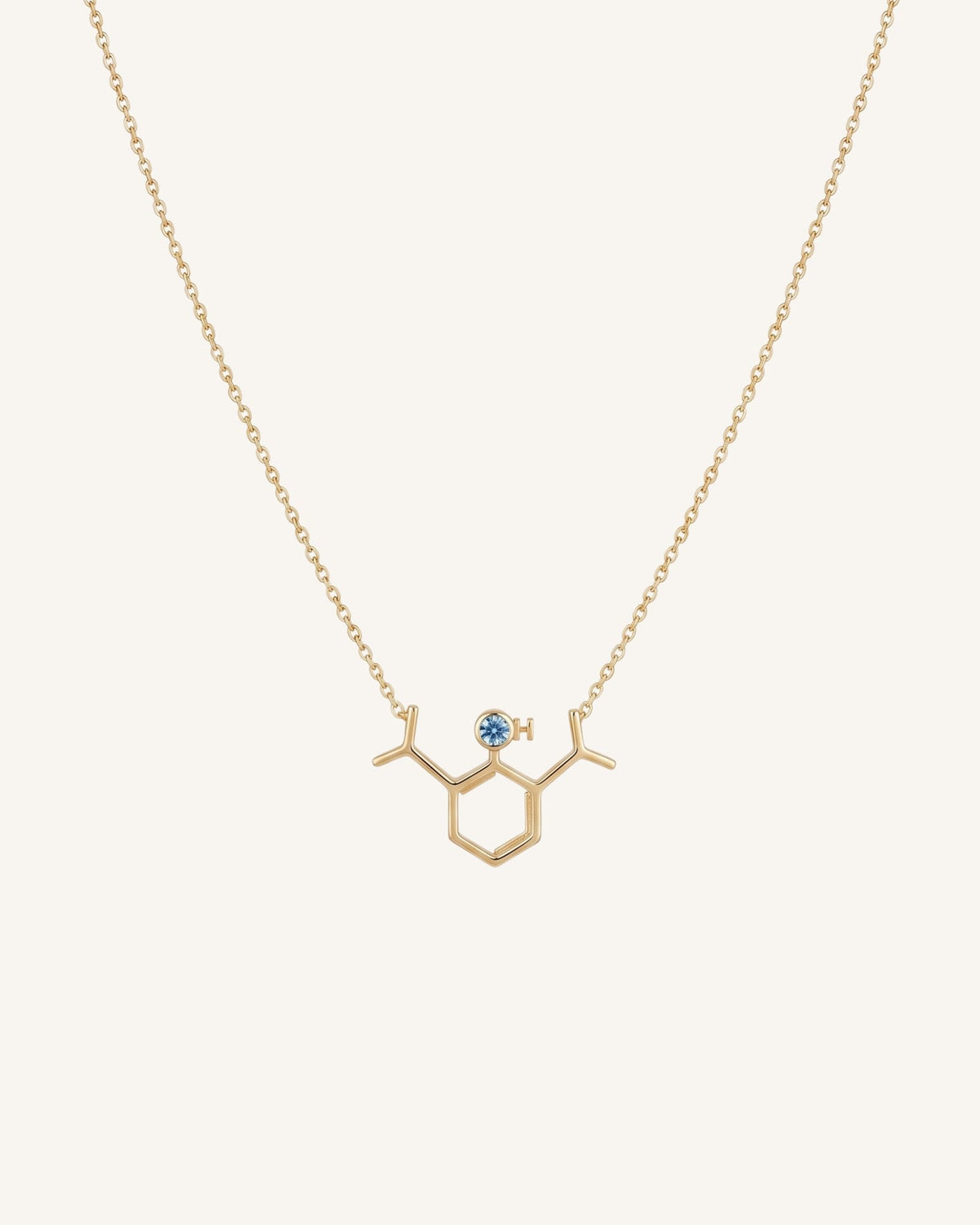 The Johanna 18K gold propofol molecule necklace with blue topaz by House of Rednam