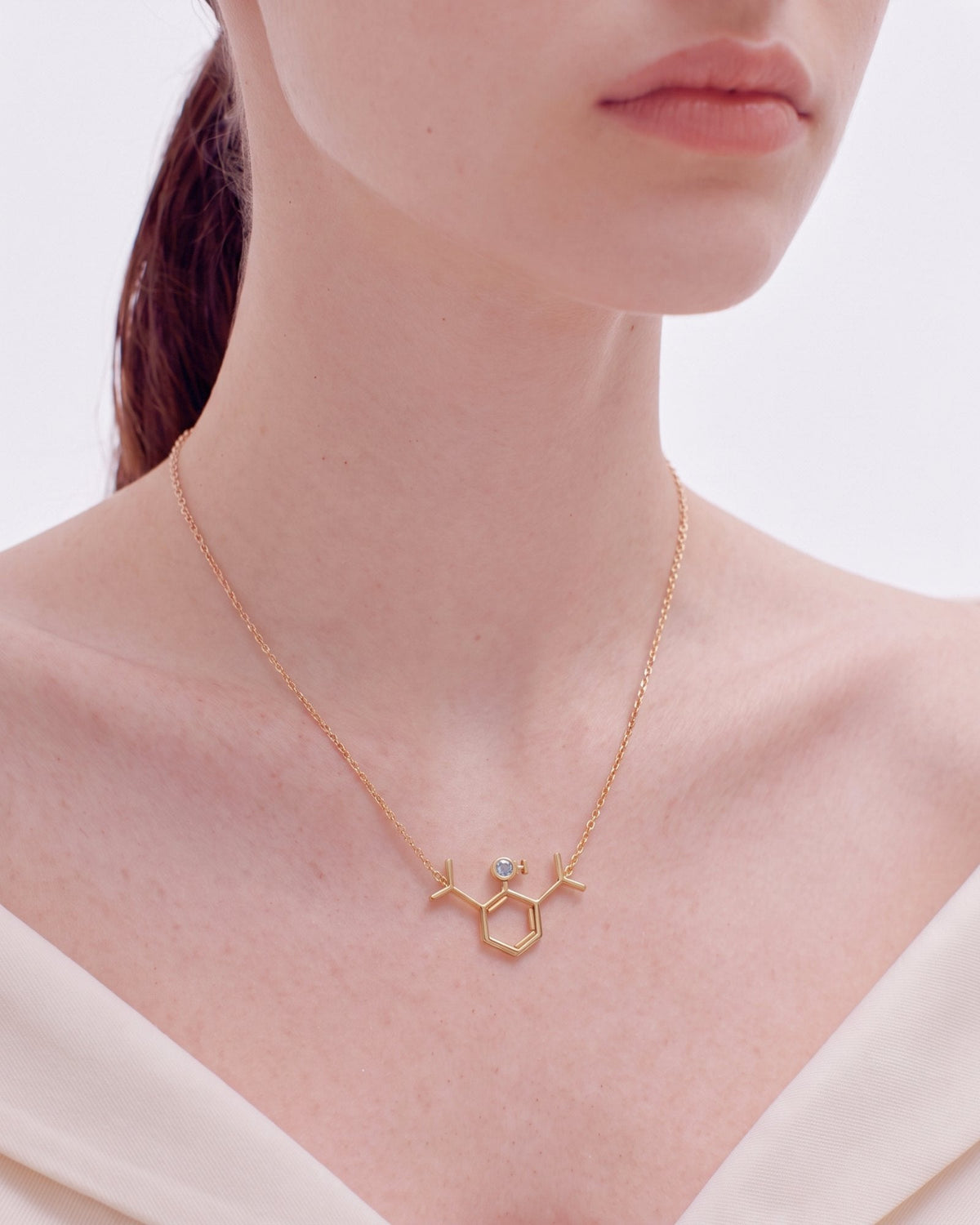 The Johanna 18K gold propofol molecule necklace with blue topaz by House of Rednam