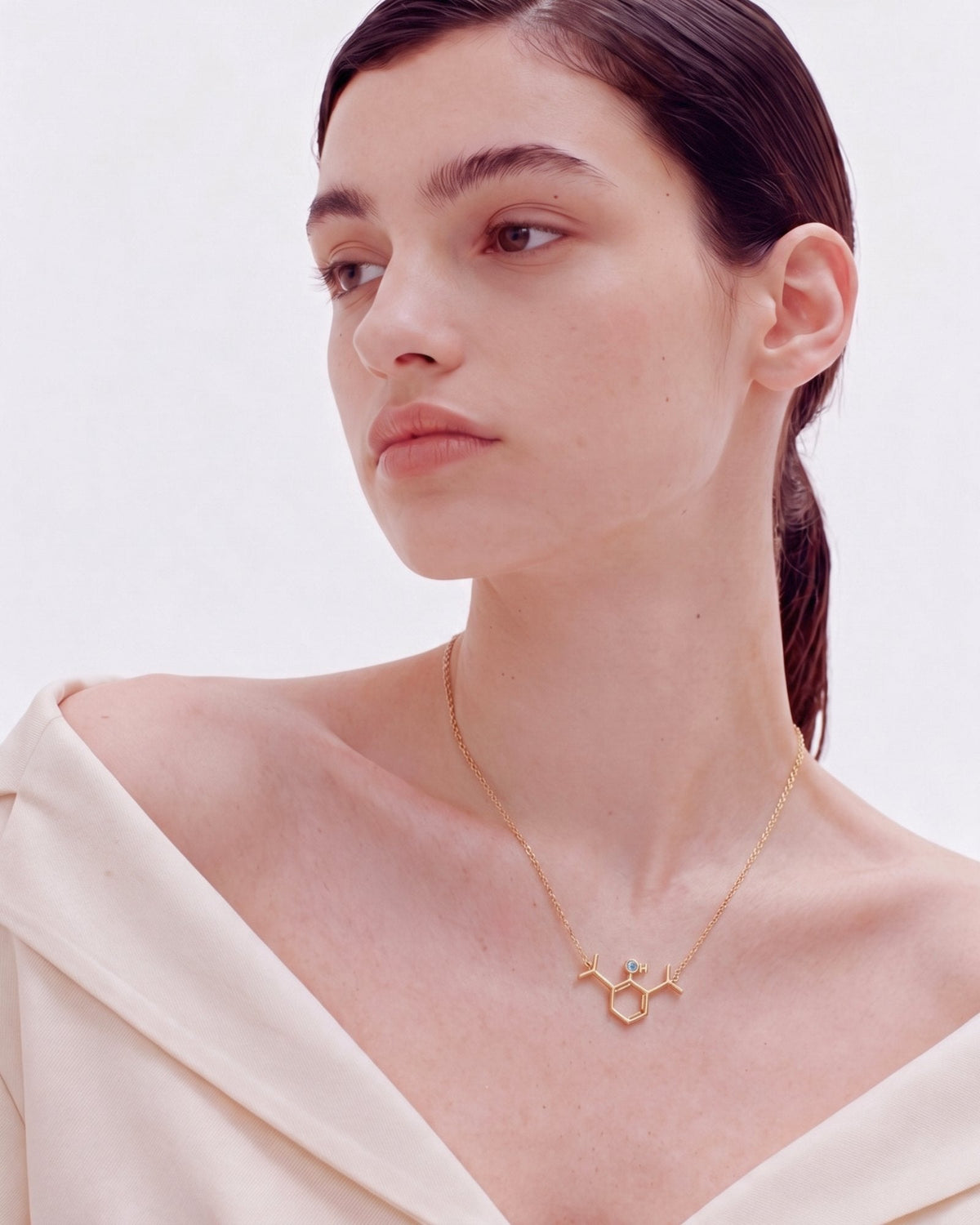 The Johanna 18K gold propofol molecule necklace with blue topaz by House of Rednam