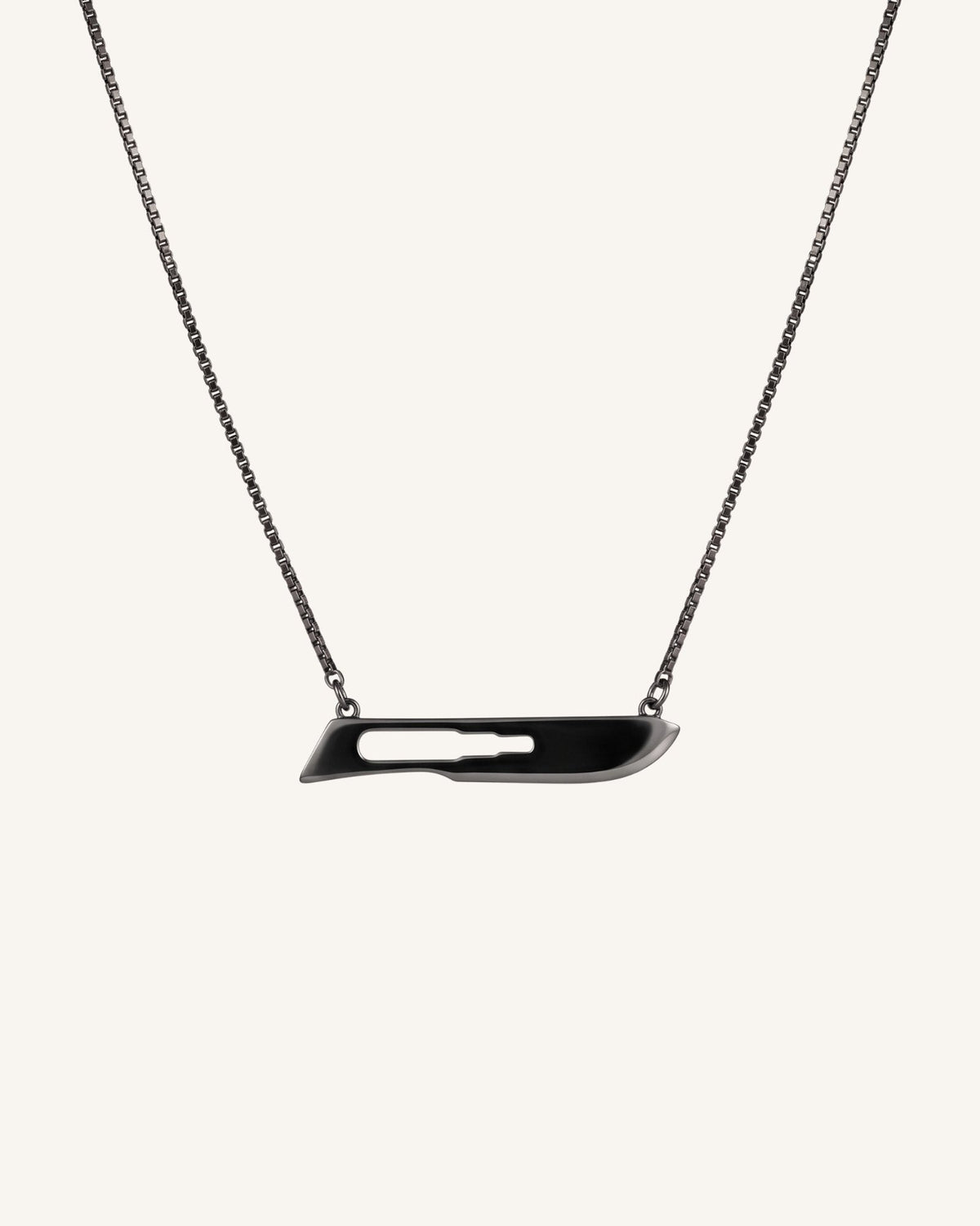 The Kiran scalpel necklace in 18K gold with black rhodium finish by House of Rednam