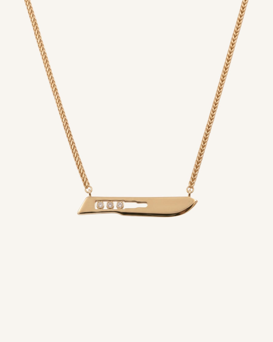 The Kiran men’s No10 scalpel necklace in 18K yellow gold with three diamonds by House of Rednam