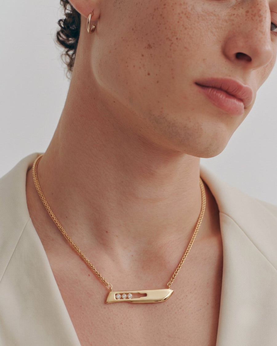 The Kiran men’s No10 scalpel necklace in 18K yellow gold with three diamonds by House of Rednam