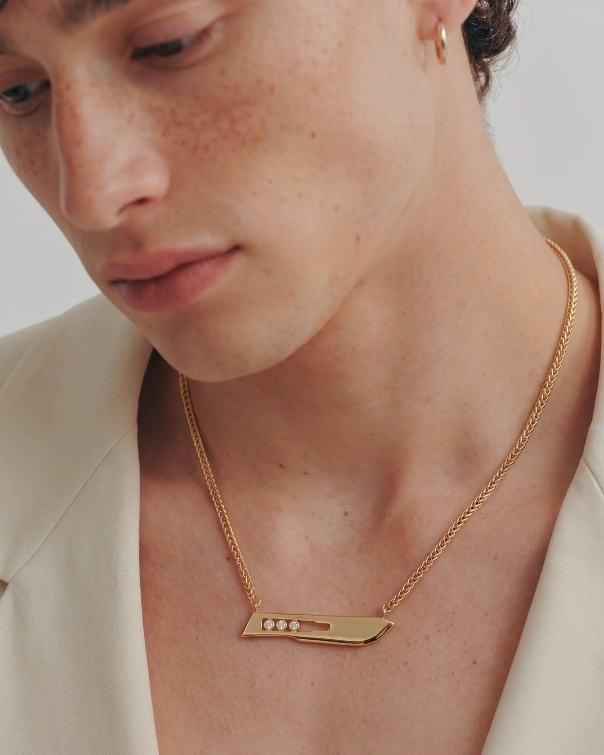 The Kiran men’s No10 scalpel necklace in 18K yellow gold with three diamonds by House of Rednam