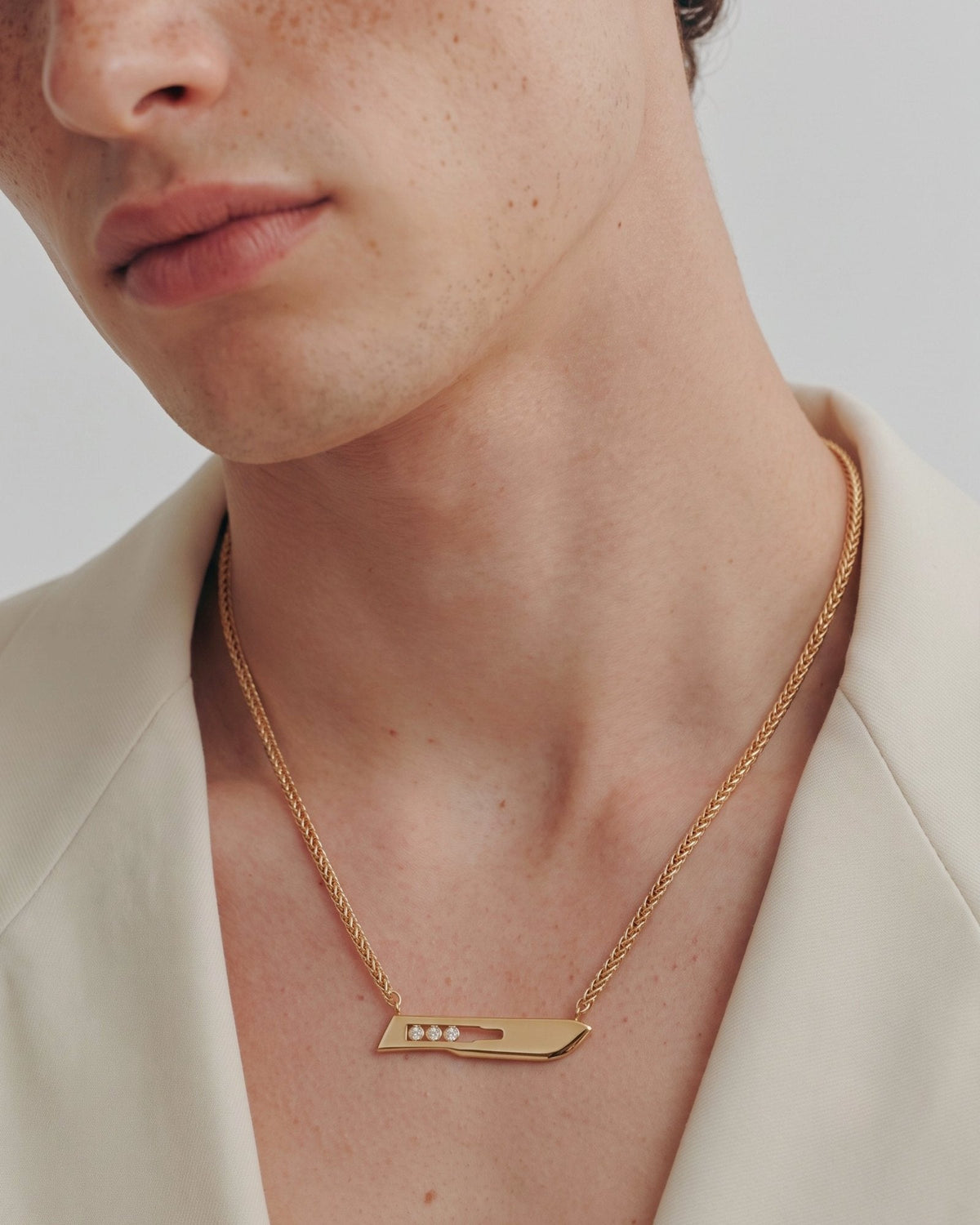 The Kiran men’s No10 scalpel necklace in 18K yellow gold with three diamonds by House of Rednam