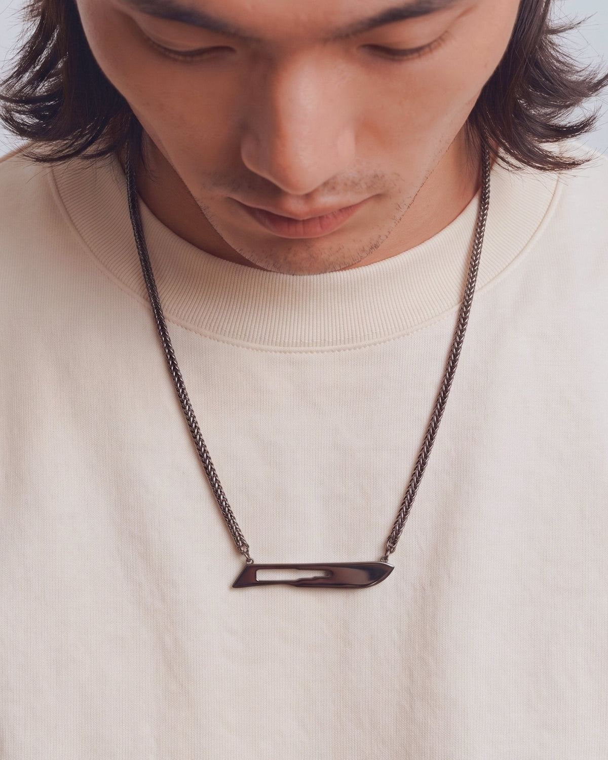 The Kiran No10 scalpel pendant in sterling silver with a black rhodium finish by House of Rednam