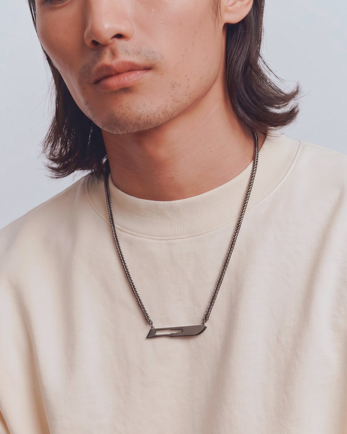 The Kiran No10 scalpel pendant in sterling silver with a black rhodium finish by House of Rednam