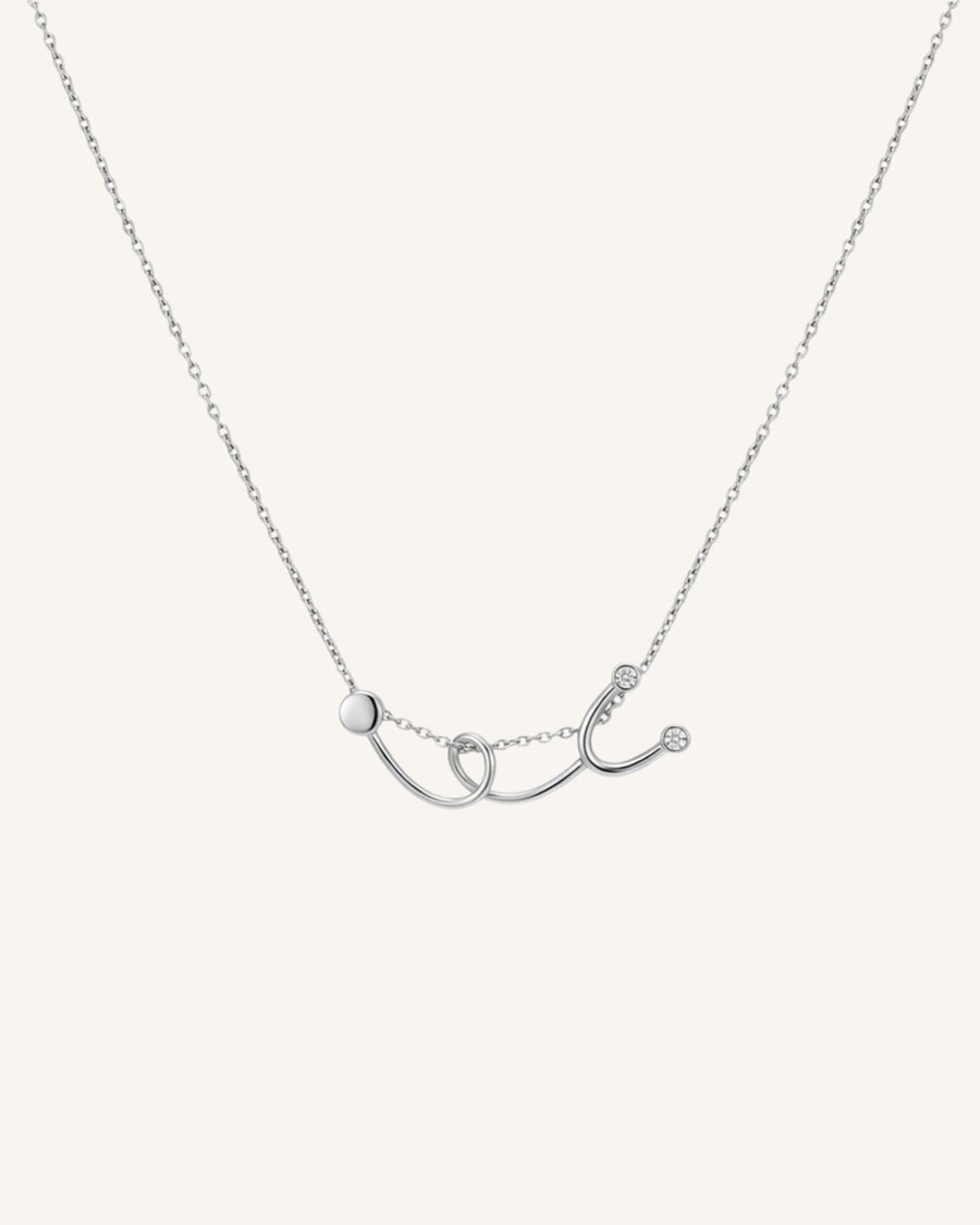 The Surya sterling silver stethoscope necklace with a diamond at each earpiece by House of Rednam