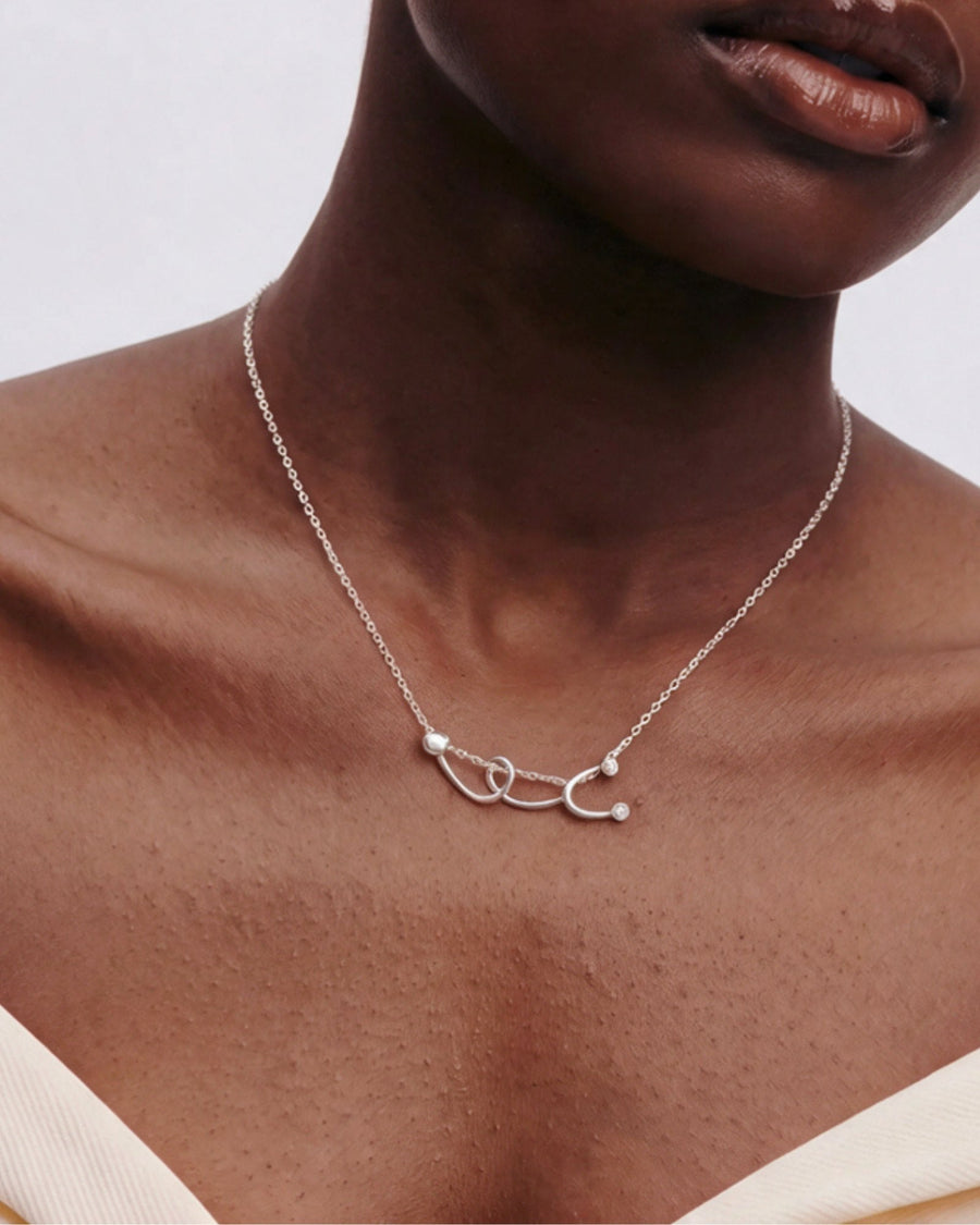 The Surya sterling silver stethoscope necklace with a diamond at each earpiece by House of Rednam