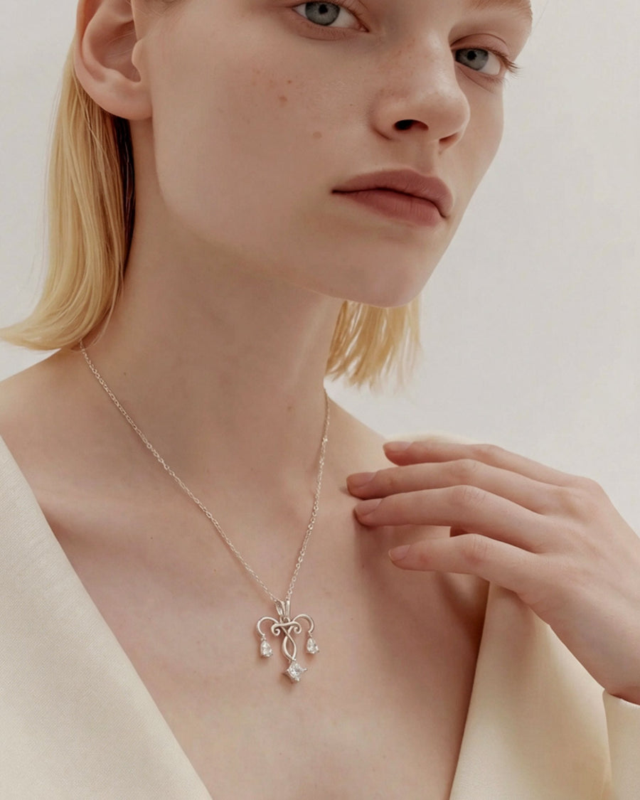 The Chandra sterling silver uterus necklace with diamond ovarian detail by House of Rednam