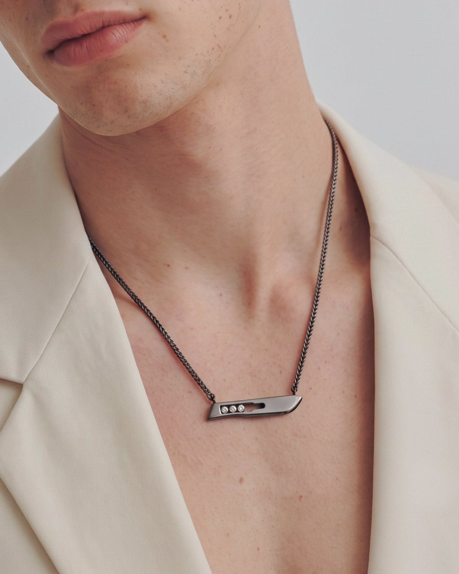The Kiran No10 scalpel pendant in sterling silver with a black rhodium finish and three diamonds by House of Rednam