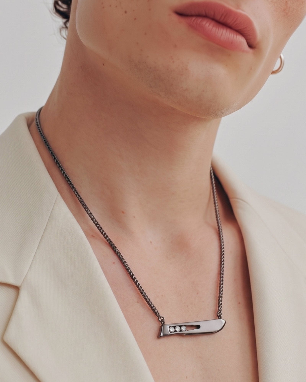 The Kiran No10 scalpel pendant in sterling silver with a black rhodium finish and three diamonds by House of Rednam, view 4