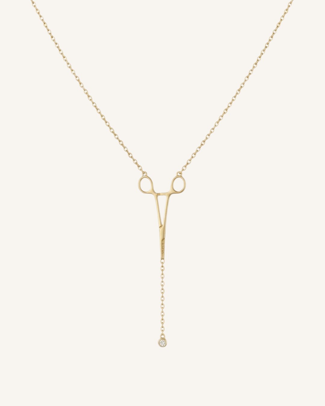The Erin 18K yellow gold hemostat necklace with a diamond at the hinge by House of Rednam