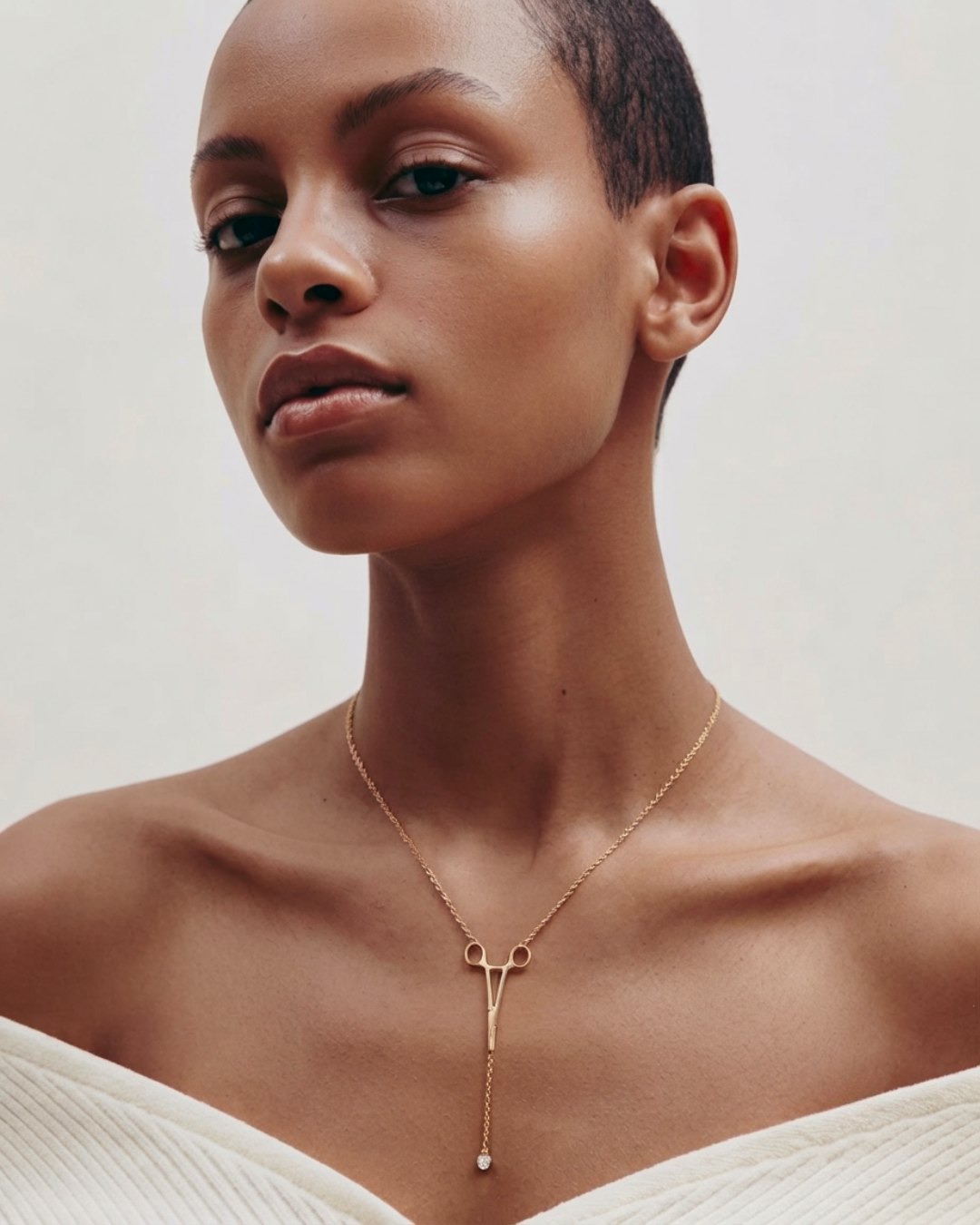 The Erin 18K yellow gold hemostat necklace with a diamond at the hinge by House of Rednam