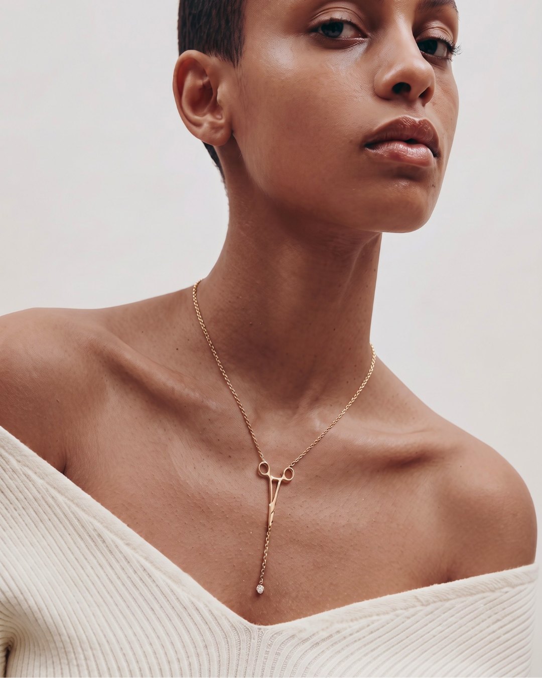 The Erin 18K yellow gold hemostat necklace with a diamond at the hinge by House of Rednam